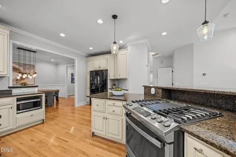 a kitchen with granite countertop stainless steel appliances sink and cabinets