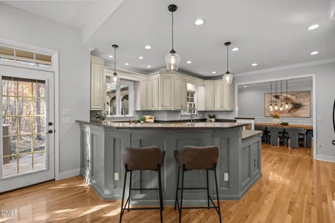 a kitchen with a stove a sink a refrigerator and cabinets