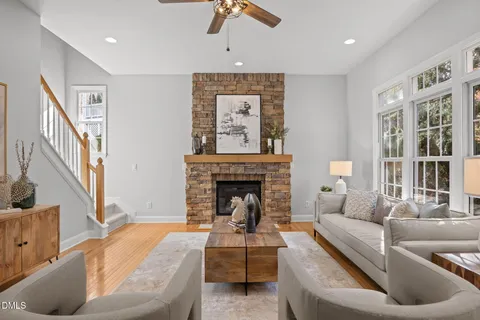 a kitchen with kitchen island granite countertop a stove a sink a oven and a dining table