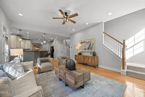 a living room with furniture and a view of kitchen