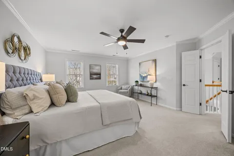 a bedroom with bed and a chandelier