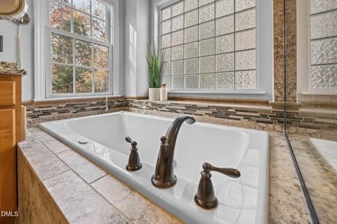 a bath tub sitting next to a window