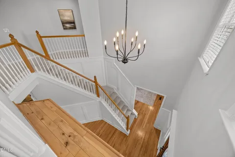 a view of staircase with railing and white walls