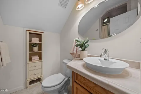 a bathroom with a granite countertop shower sink and mirror