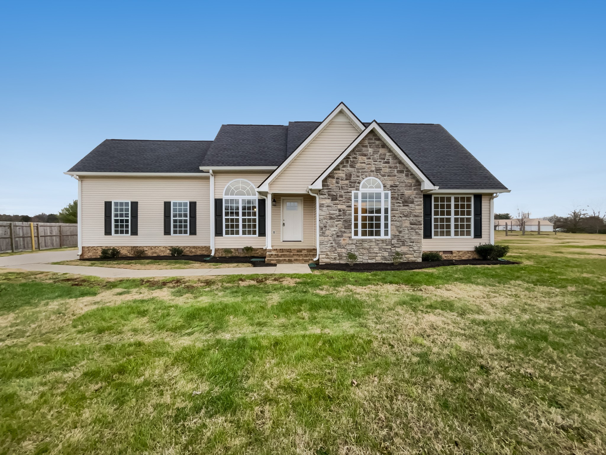a front view of a house with a garden