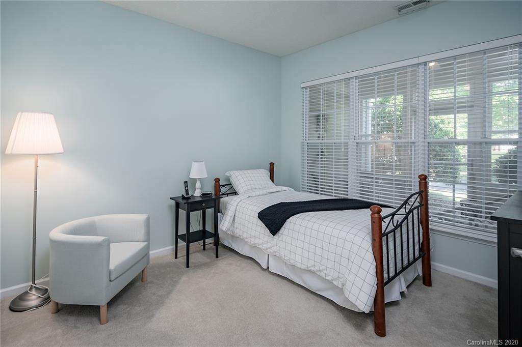 16616 Timber Crossing Road Charlotte, NC 28213 - Photo 14 of 40 a bedroom with a bed and a chandelier