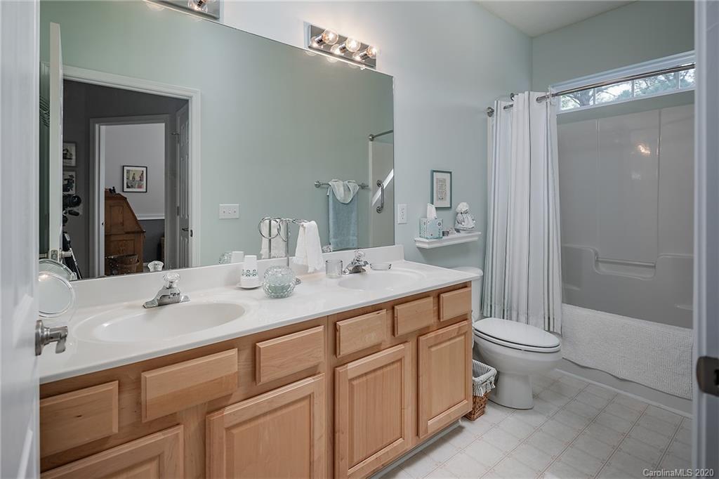 16616 Timber Crossing Road Charlotte, NC 28213 - Photo 16 of 40 a bathroom with a double vanity sink toilet and shower