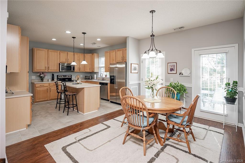 16616 Timber Crossing Road Charlotte, NC 28213 - Photo 17 of 40 a dining room filled counter top space and a chandelier