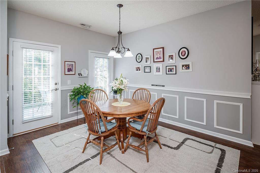 16616 Timber Crossing Road Charlotte, NC 28213 - Photo 18 of 40 a view of a dining room with furniture window and wooden floor