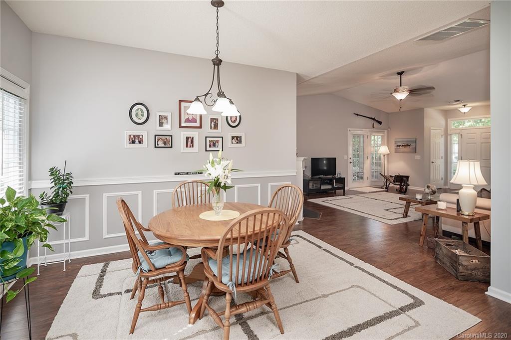 16616 Timber Crossing Road Charlotte, NC 28213 - Photo 19 of 40 a view of a dining room and livingroom with furniture wooden floor a chandelier