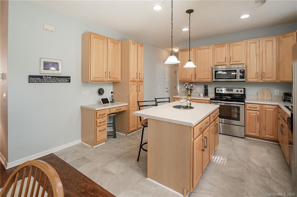 16616 Timber Crossing Road Charlotte, NC 28213 - Photo 20 of 40 a kitchen a sink a microwave a stove and white cabinets
