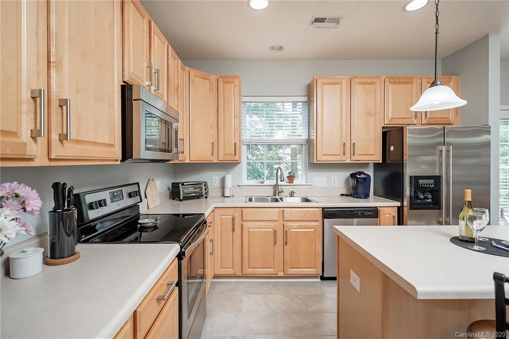 16616 Timber Crossing Road Charlotte, NC 28213 - Photo 24 of 40 a kitchen with a sink a stove and cabinets