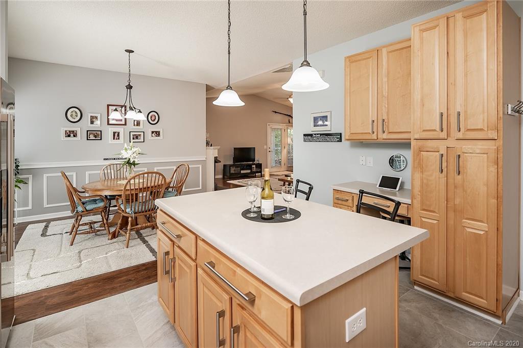 16616 Timber Crossing Road Charlotte, NC 28213 - Photo 25 of 40 a kitchen with stainless steel appliances granite countertop a sink a stove and chairs