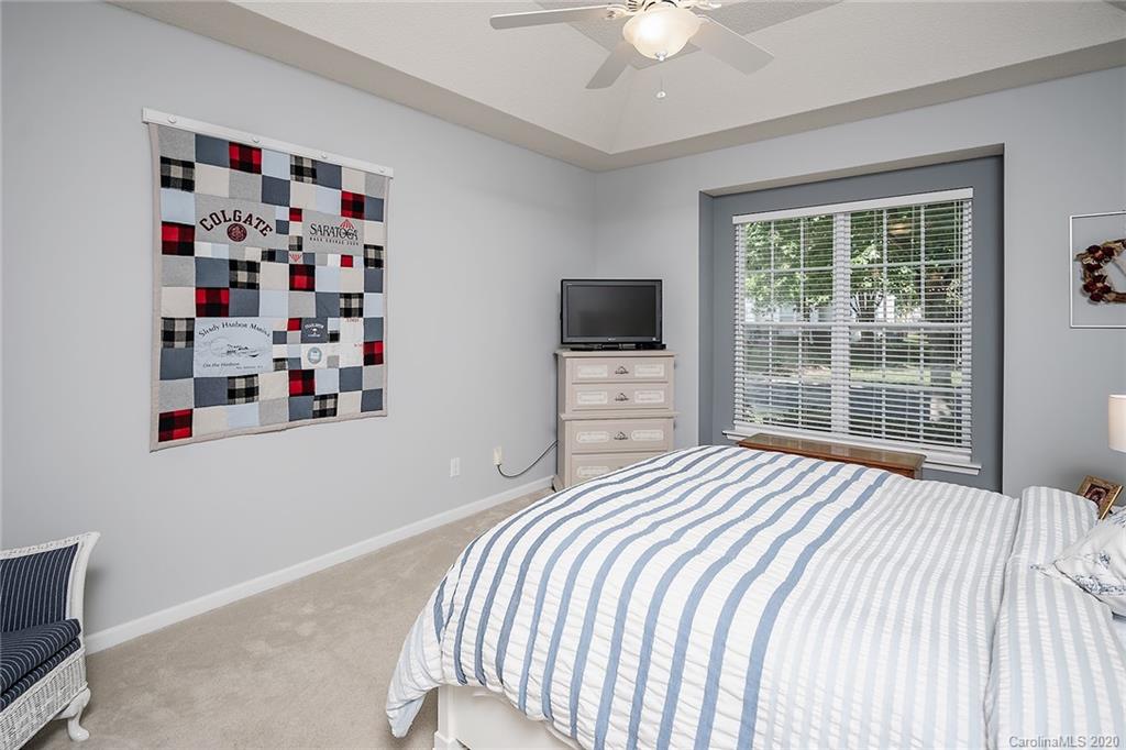 16616 Timber Crossing Road Charlotte, NC 28213 - Photo 28 of 40 a bedroom with a bed a window and a flat screen tv