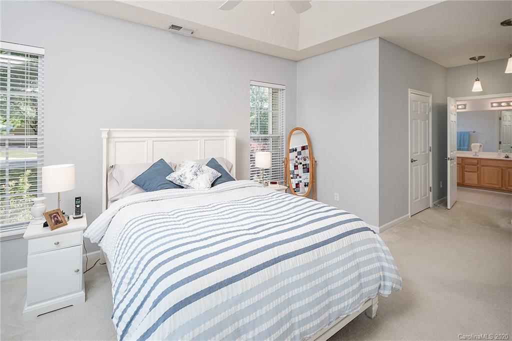 16616 Timber Crossing Road Charlotte, NC 28213 - Photo 30 of 40 a bedroom with a bed and a large mirror