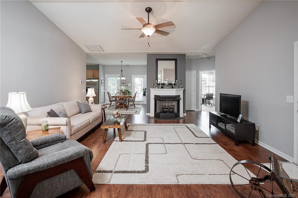 16616 Timber Crossing Road Charlotte, NC 28213 - Photo 6 of 40 a living room with furniture a fireplace and a flat screen tv