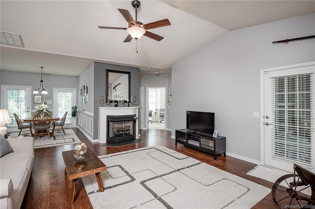 16616 Timber Crossing Road Charlotte, NC 28213 - Photo 7 of 40 a living room with furniture a fireplace and a flat screen tv
