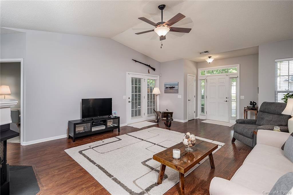 16616 Timber Crossing Road Charlotte, NC 28213 - Photo 8 of 40 a living room with furniture a fireplace and a flat screen tv