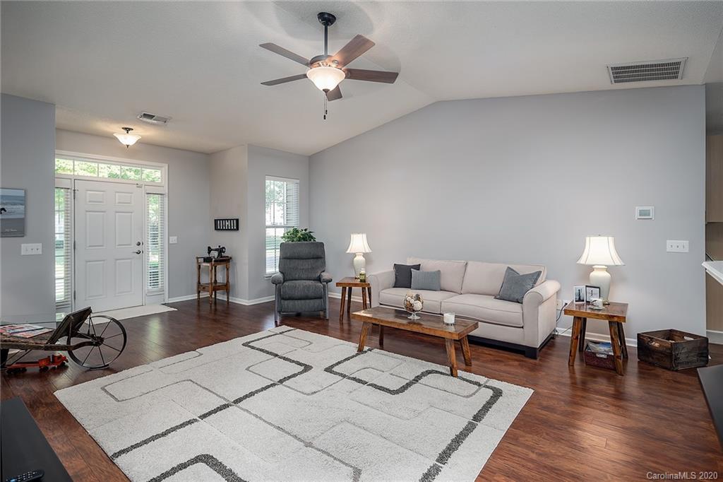 16616 Timber Crossing Road Charlotte, NC 28213 - Photo 10 of 40 a living room with furniture a chandelier and a rug