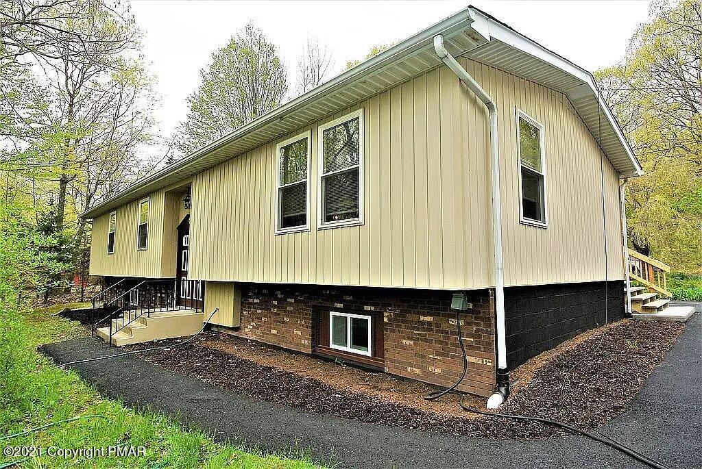 143 Britt Court Cresco, PA 18326 - Photo 1 of 35 a front view of a house with a yard