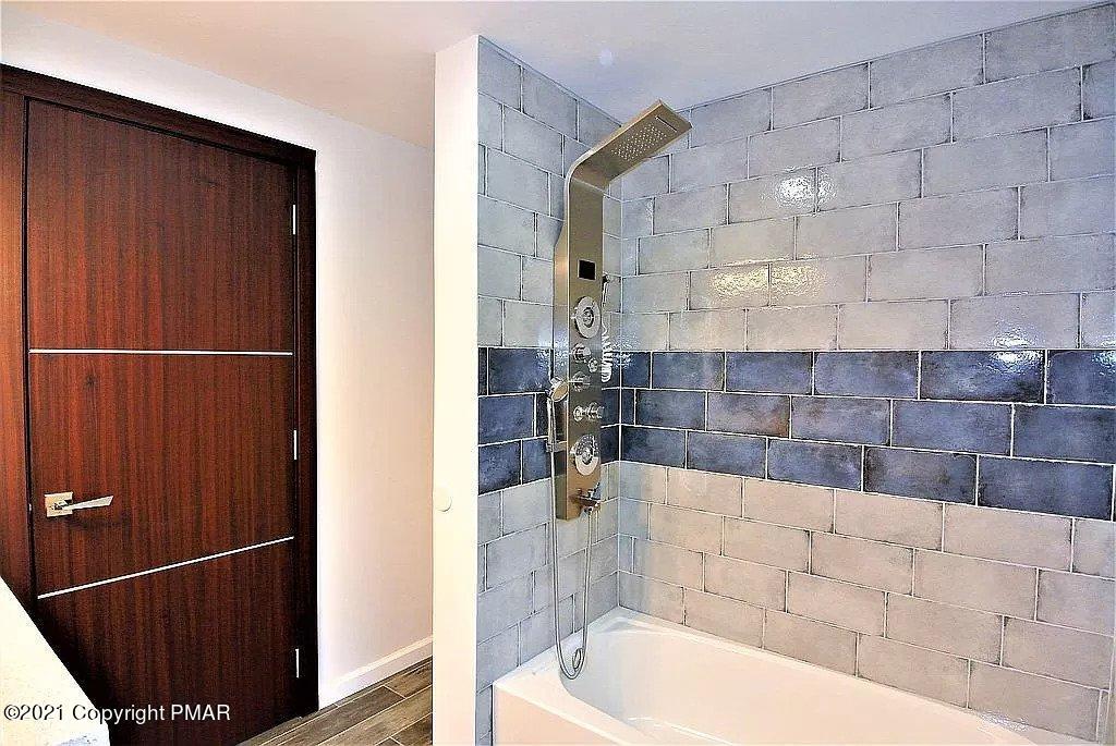 143 Britt Court Cresco, PA 18326 - Photo 14 of 35 a bathroom with a bathtub and shower