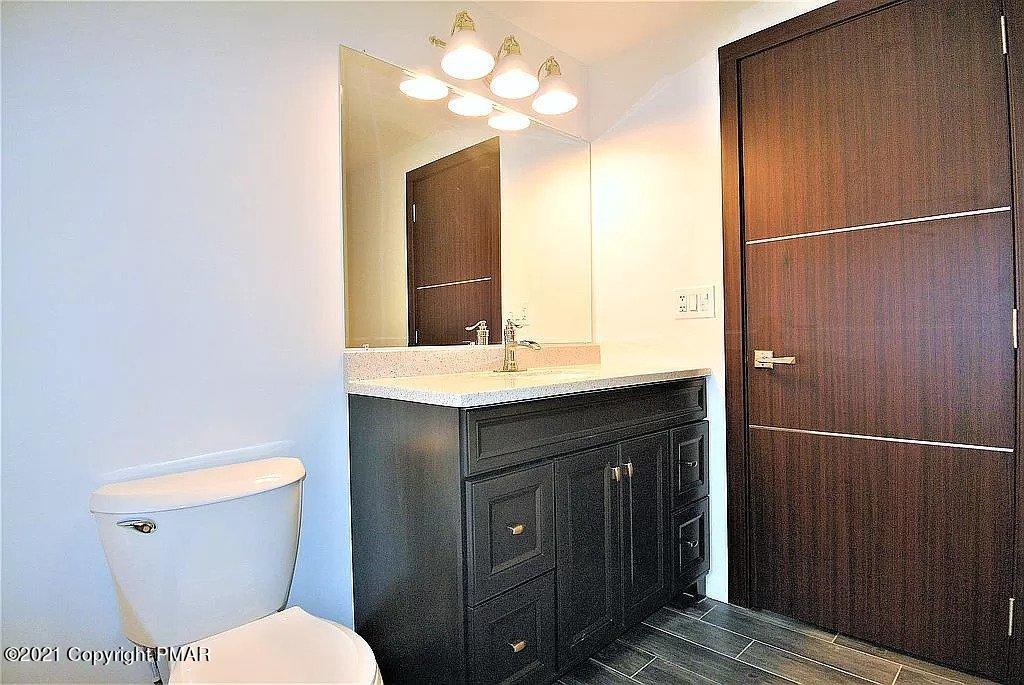 143 Britt Court Cresco, PA 18326 - Photo 18 of 35 a bathroom with a sink a toilet and mirror