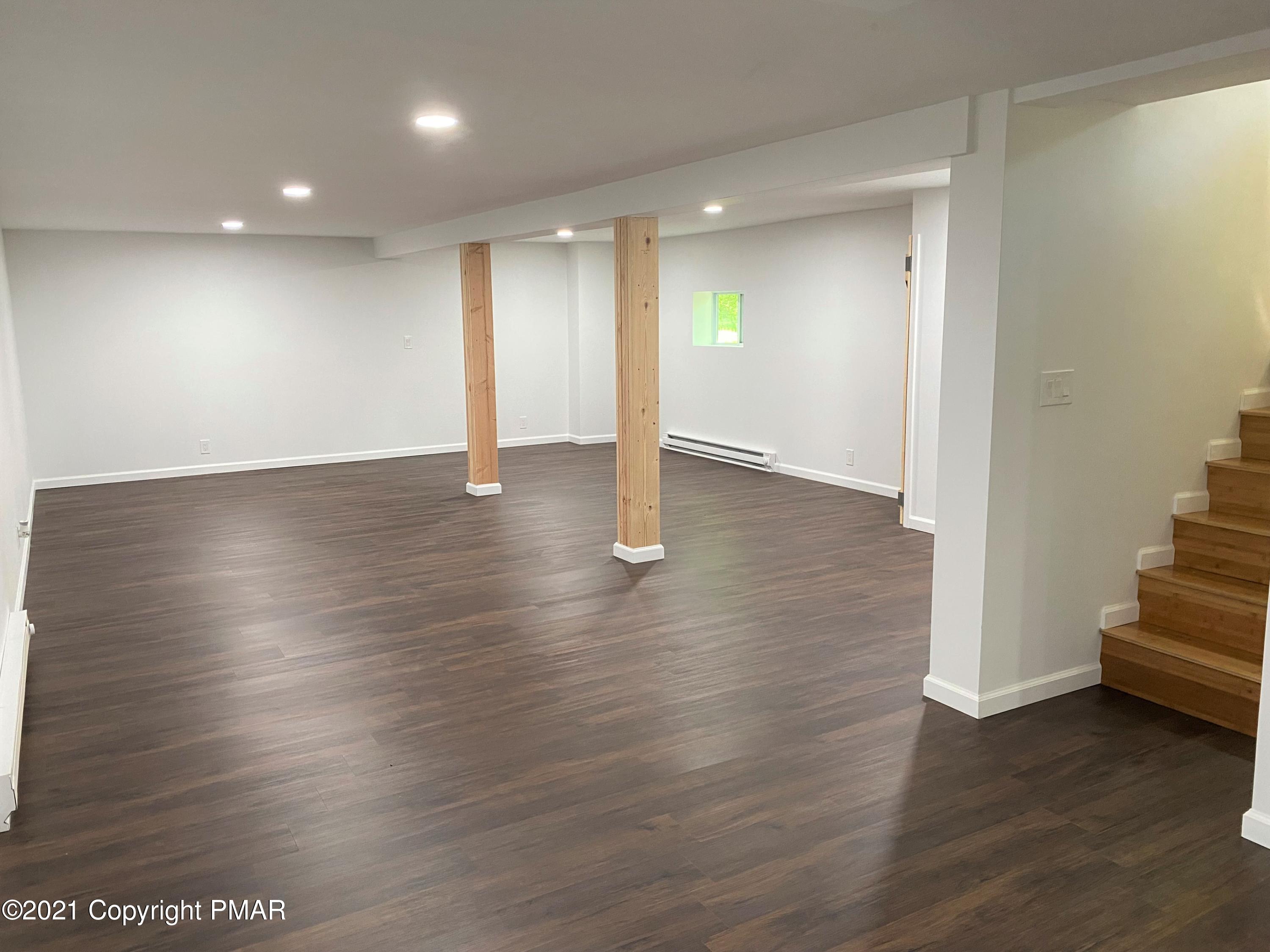 143 Britt Court Cresco, PA 18326 - Photo 23 of 35 an empty room with wooden floor and windows