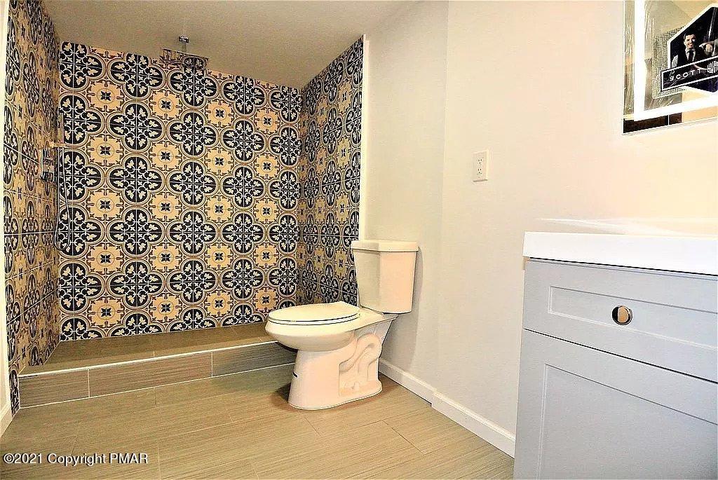 143 Britt Court Cresco, PA 18326 - Photo 28 of 35 a bathroom with a toilet and a shower curtain