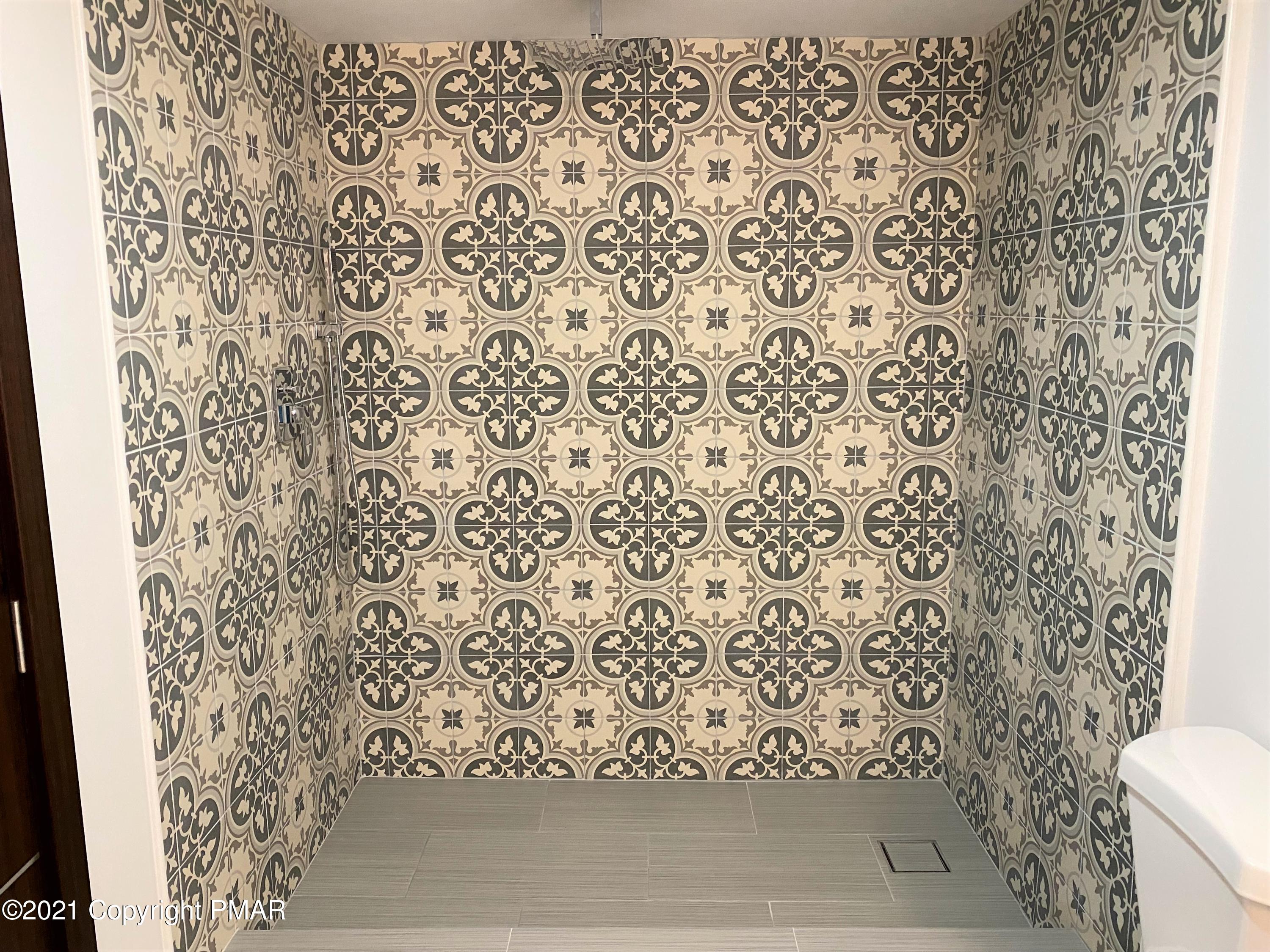 143 Britt Court Cresco, PA 18326 - Photo 29 of 35 a bathroom with a toilet and a shower curtain