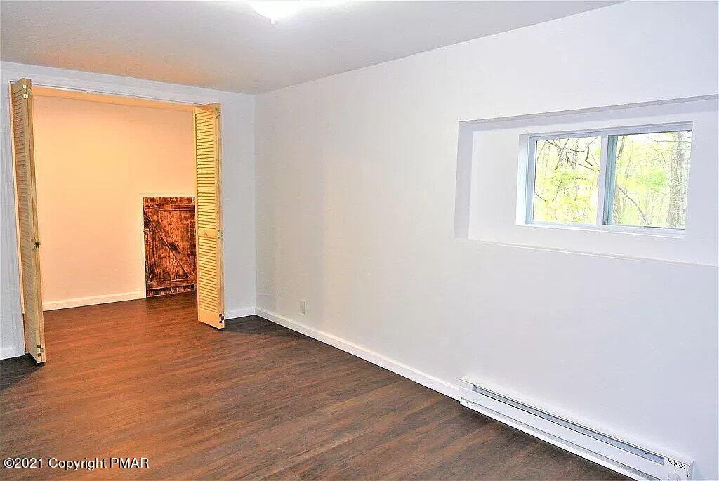 143 Britt Court Cresco, PA 18326 - Photo 31 of 35 an empty room with wooden floor and windows