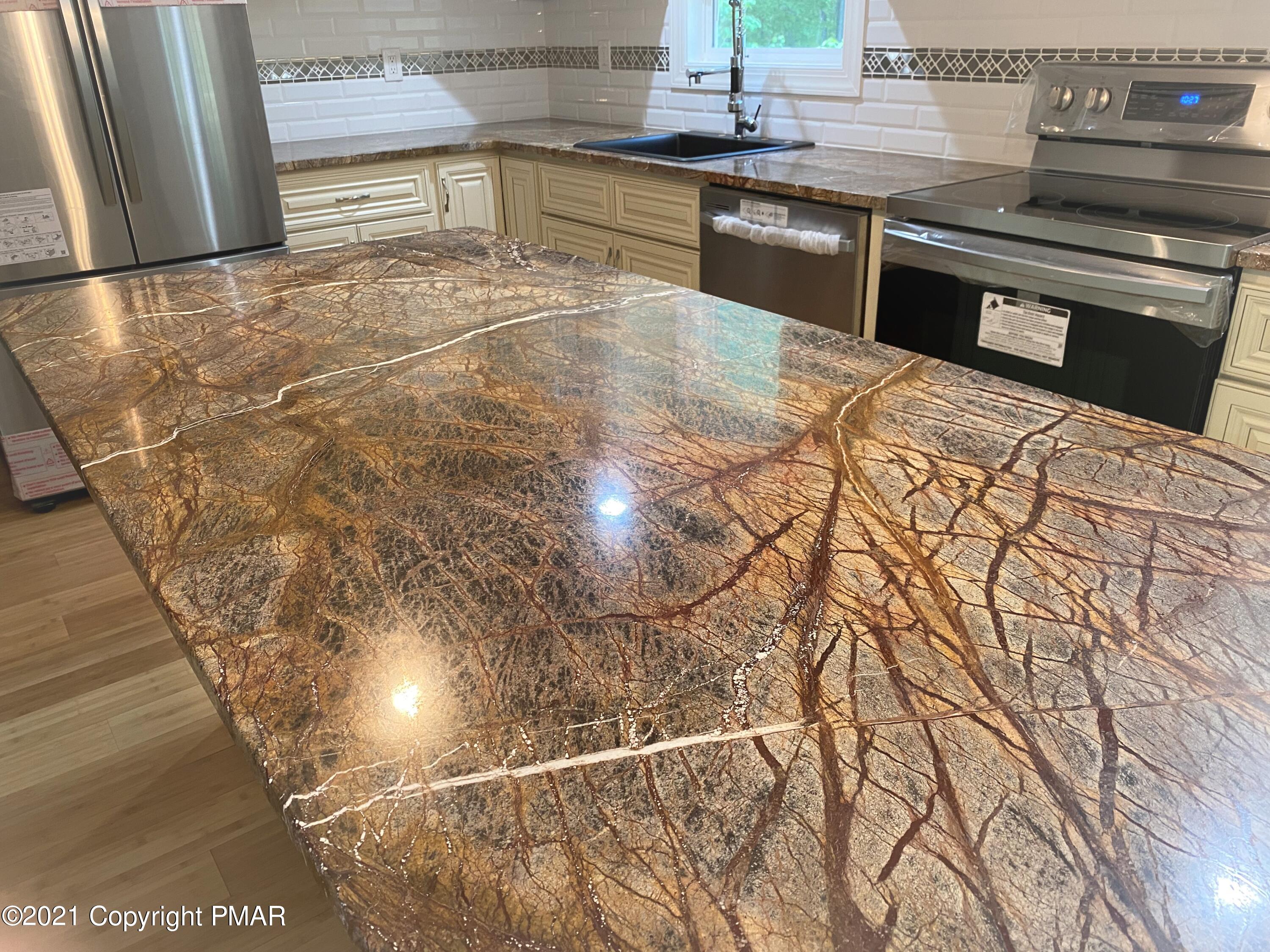 143 Britt Court Cresco, PA 18326 - Photo 4 of 35 a kitchen with kitchen island granite countertop a stove and a sink