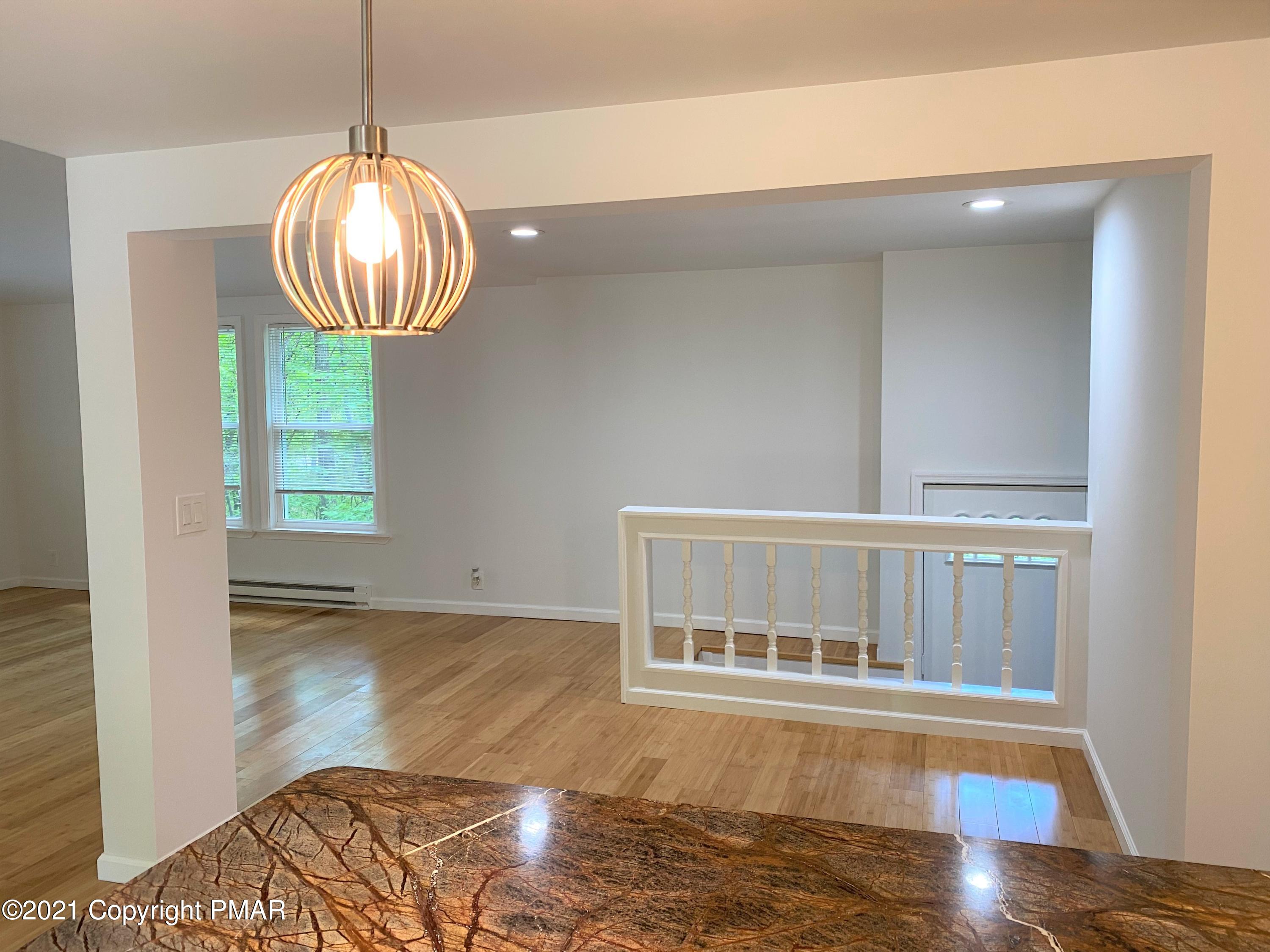 143 Britt Court Cresco, PA 18326 - Photo 6 of 35 a view of an empty room with wooden floor and a window