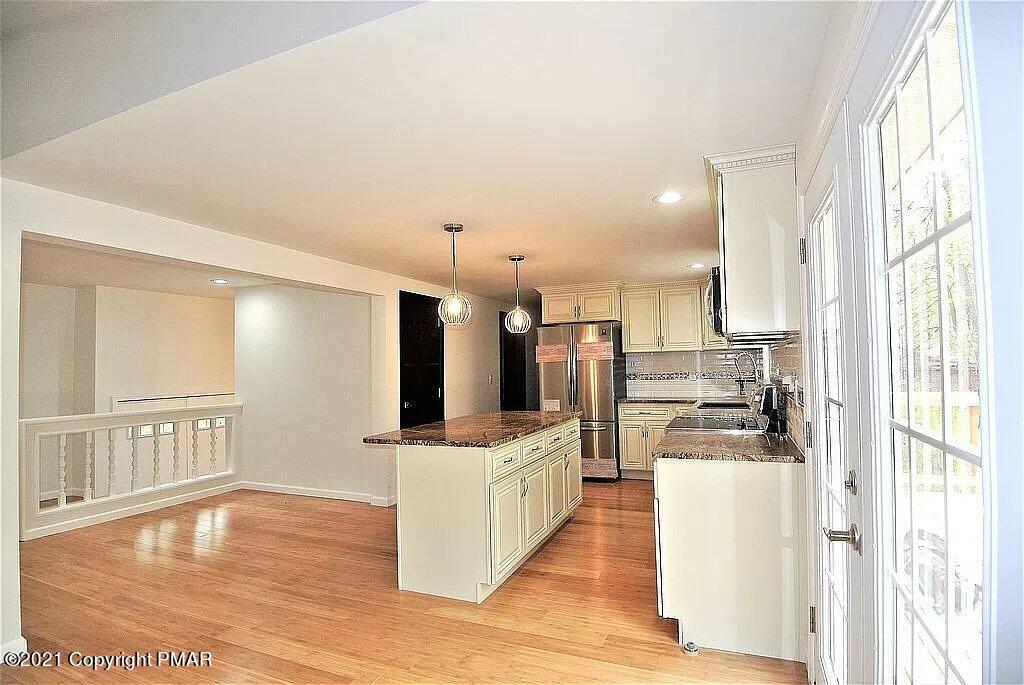 143 Britt Court Cresco, PA 18326 - Photo 7 of 35 a kitchen with stainless steel appliances kitchen island granite countertop a refrigerator oven a sink and dishwasher with wooden floor