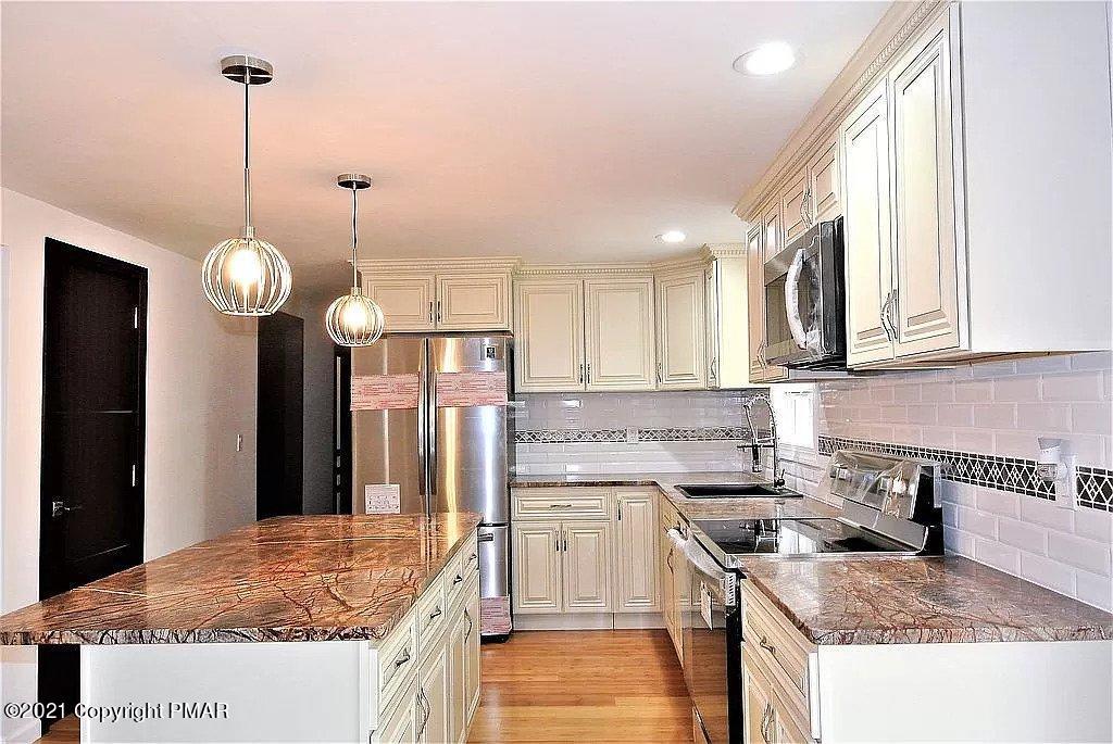 143 Britt Court Cresco, PA 18326 - Photo 8 of 35 a kitchen with a sink stove and refrigerator