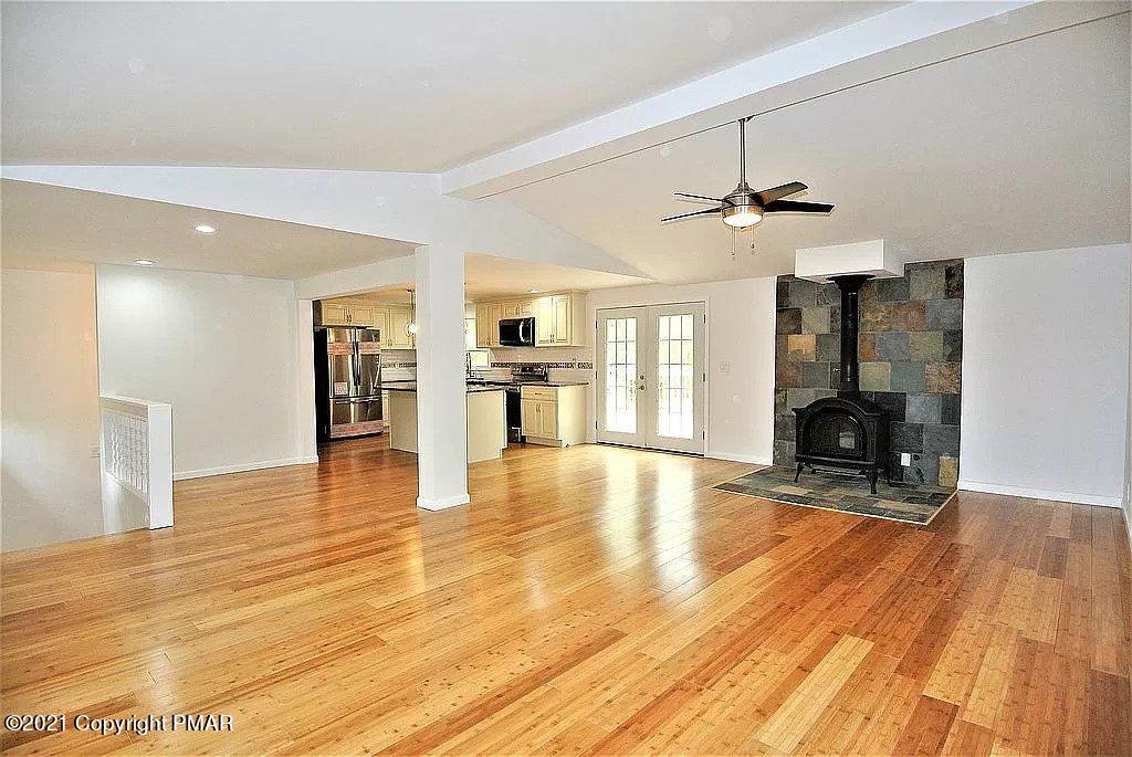 143 Britt Court Cresco, PA 18326 - Photo 10 of 35 a view of a livingroom with wooden floor and a kitchen space