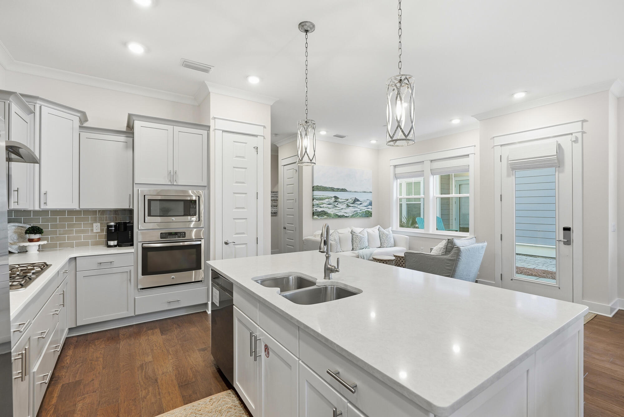 23 East York Ln Inlet Beach, Unit A Inlet Beach, FL 32461 - Photo 14 of 51 a large white kitchen with a large window a sink and stainless steel appliances