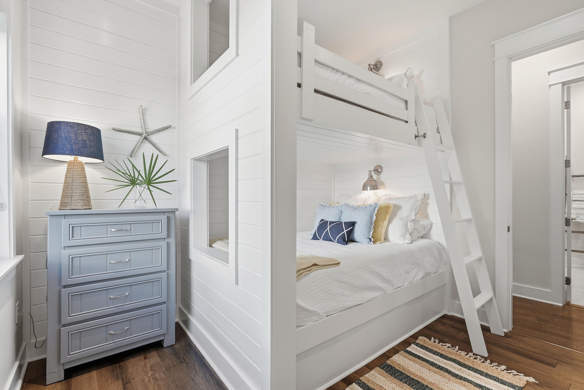 23 East York Ln Inlet Beach, Unit A Inlet Beach, FL 32461 - Photo 21 of 51 a room with a bed and a lamp on the dresser