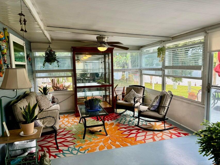 5248 Southeast 43rd Trace Okeechobee, FL 34974 - Photo 19 of 35 a living room with furniture a fireplace and a floor to ceiling window
