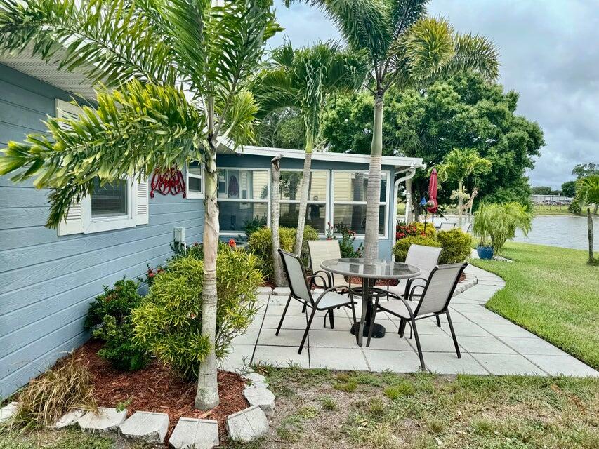 5248 Southeast 43rd Trace Okeechobee, FL 34974 - Photo 23 of 35 a view of a chairs and table in backyard of the house