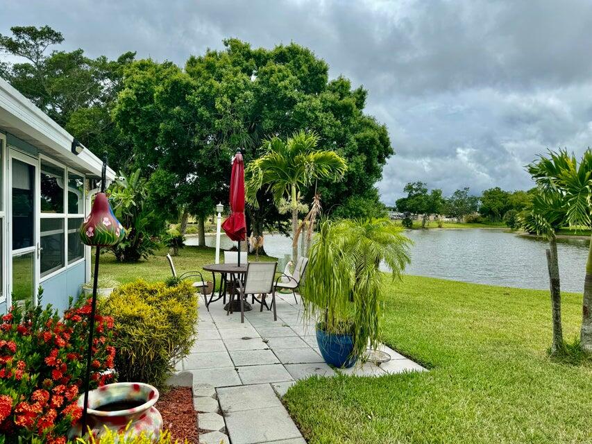 5248 Southeast 43rd Trace Okeechobee, FL 34974 - Photo 25 of 35 a view of a garden with plants and a bench