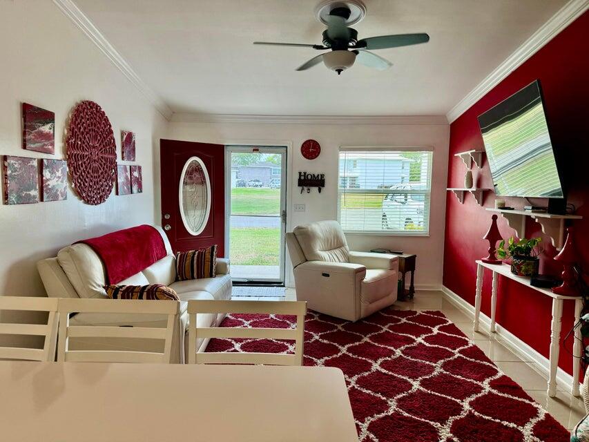 5248 Southeast 43rd Trace Okeechobee, FL 34974 - Photo 4 of 35 a living room with a couch and a flat screen tv