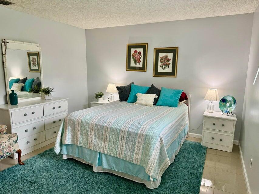 5248 Southeast 43rd Trace Okeechobee, FL 34974 - Photo 7 of 35 a bedroom with a bed and a dresser