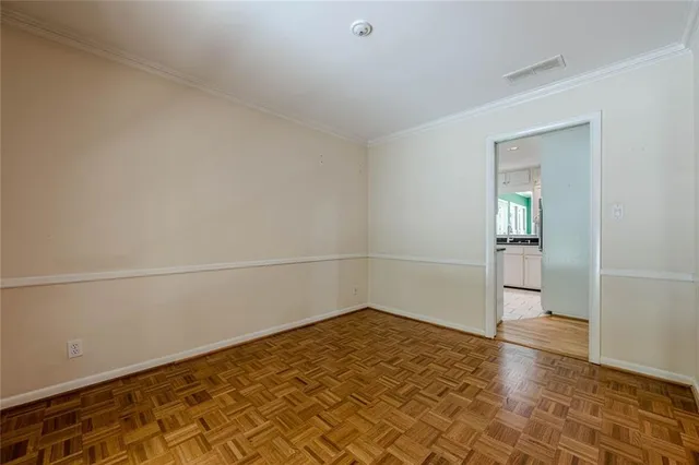 a kitchen with white cabinets and refrigerator