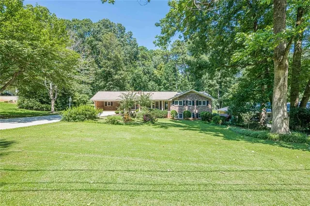 a view of a house with a yard and sitting area
