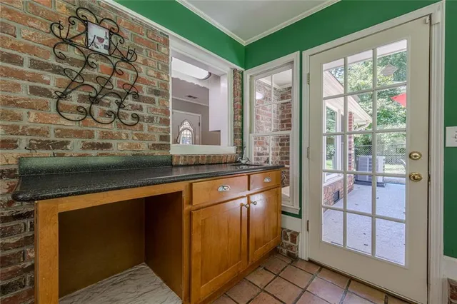 an empty room with chandelier fan and windows