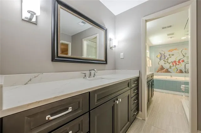 a bathroom with a sink a mirror and shower