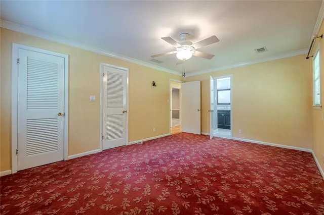 a utility room with stainless steel appliances lots of wooden furniture