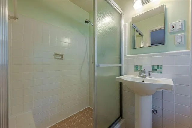 a view of a house with a yard and potted plants