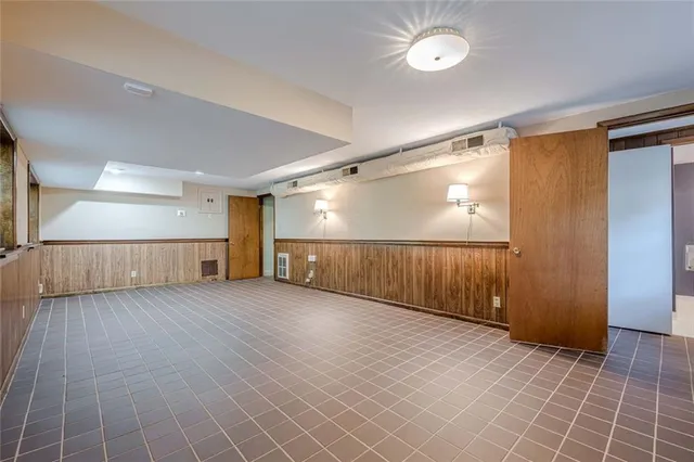 an aerial view of residential house with outdoor space and trees all around