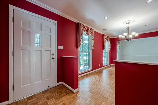 a view of an empty room with window and stairs